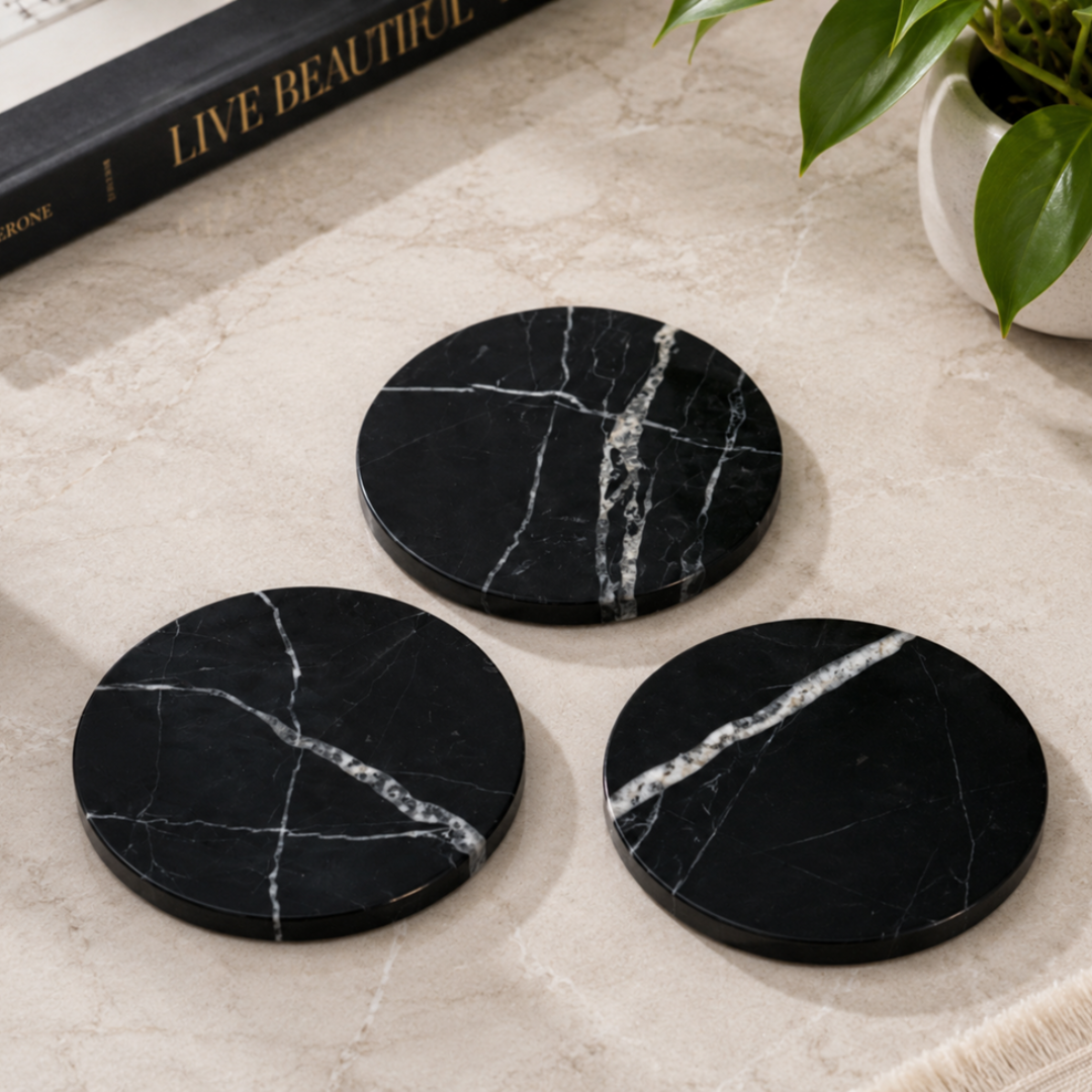 Black natural marble round coasters with white veining

