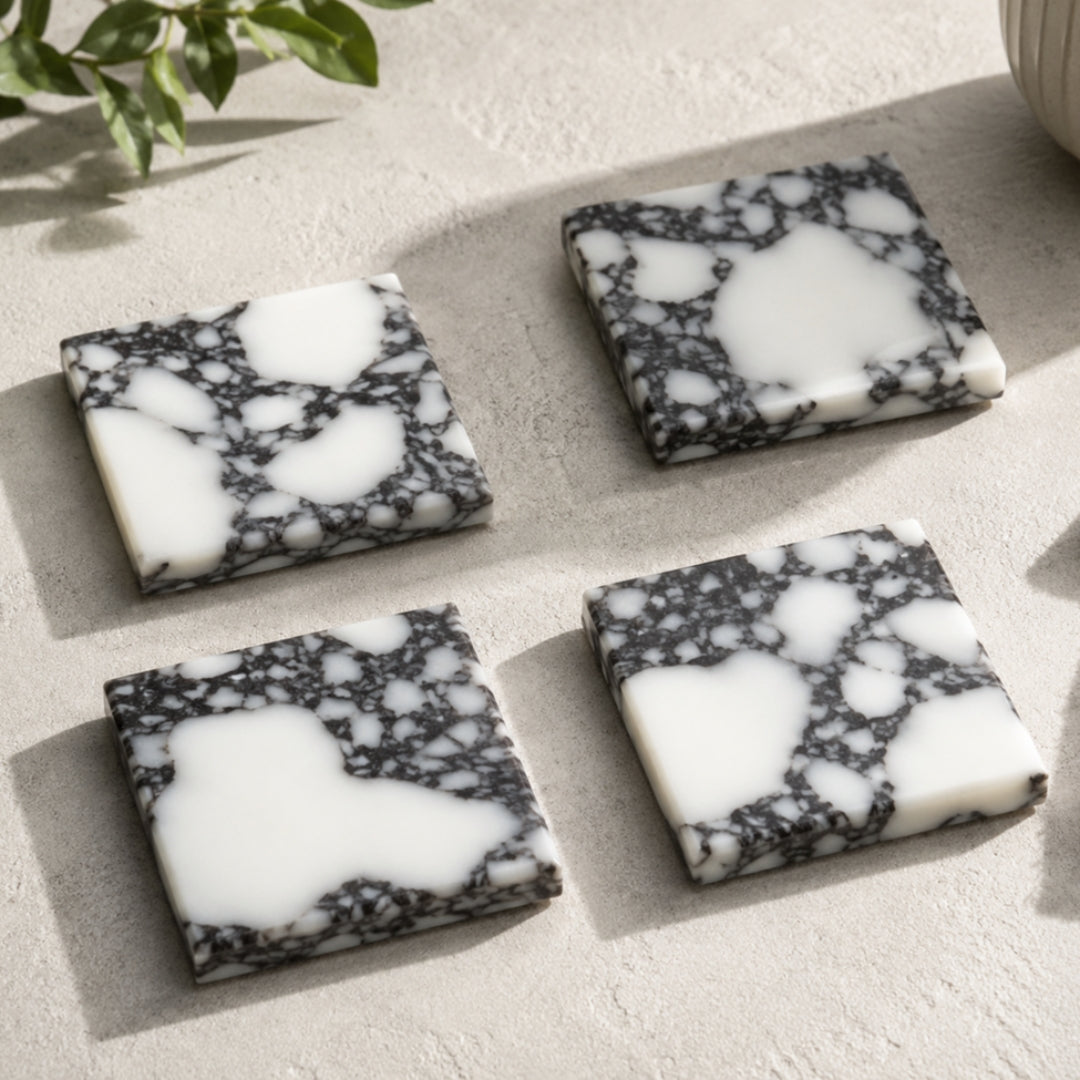 Calacatta Viola marble square coasters with white and dark veining
