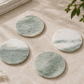 Round green natural marble coasters with white veining
