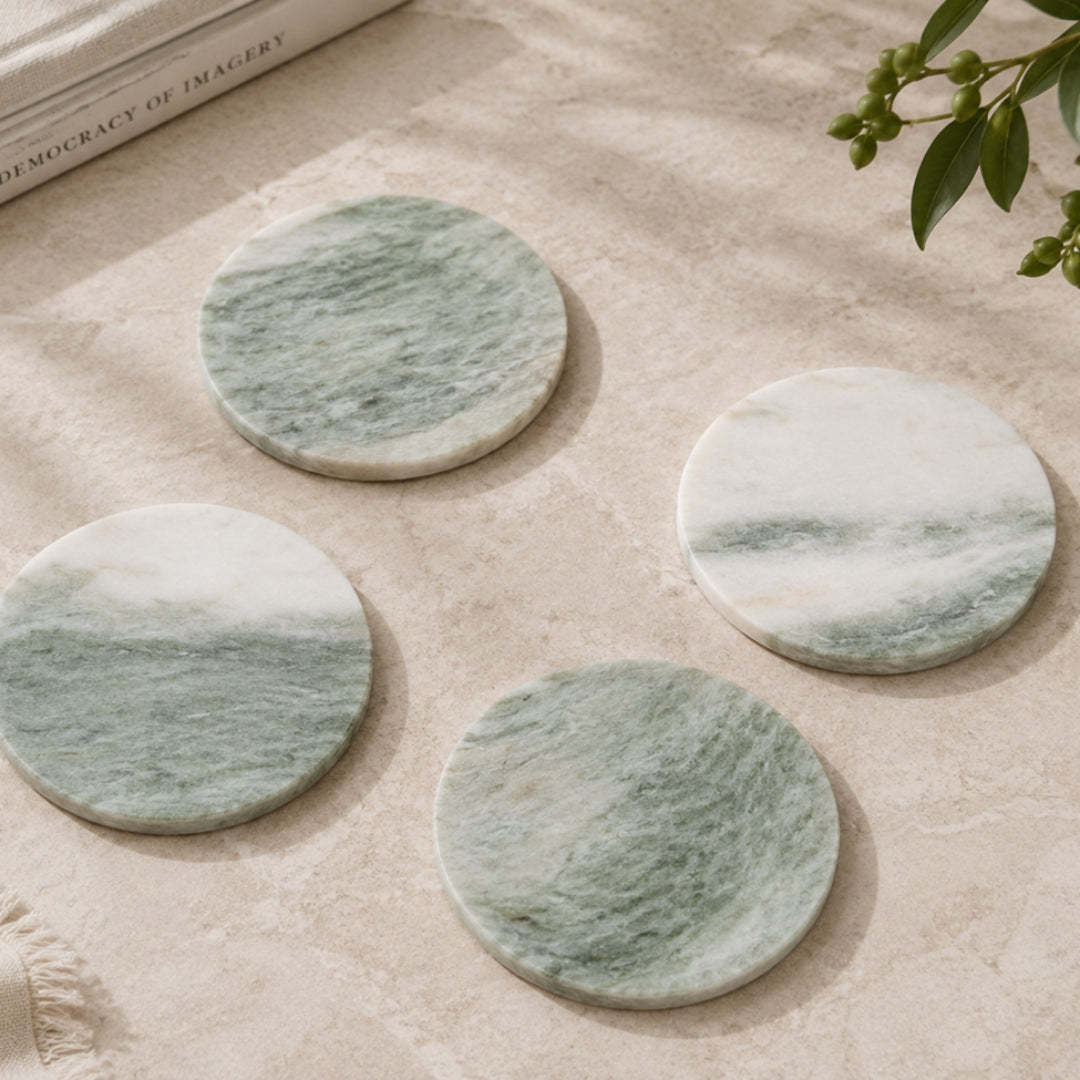 Round green natural marble coasters with white veining
