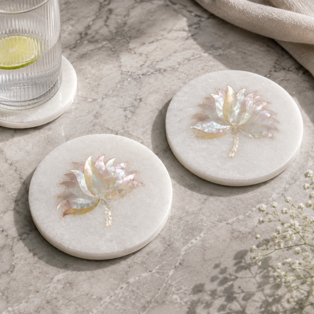 Luxury handmade white marble coaster set featuring genuine Mother of Pearl lotus inlay for hotels, interior designers, wholesalers, importers, and hospitality projects manufactured by Sarte International.
